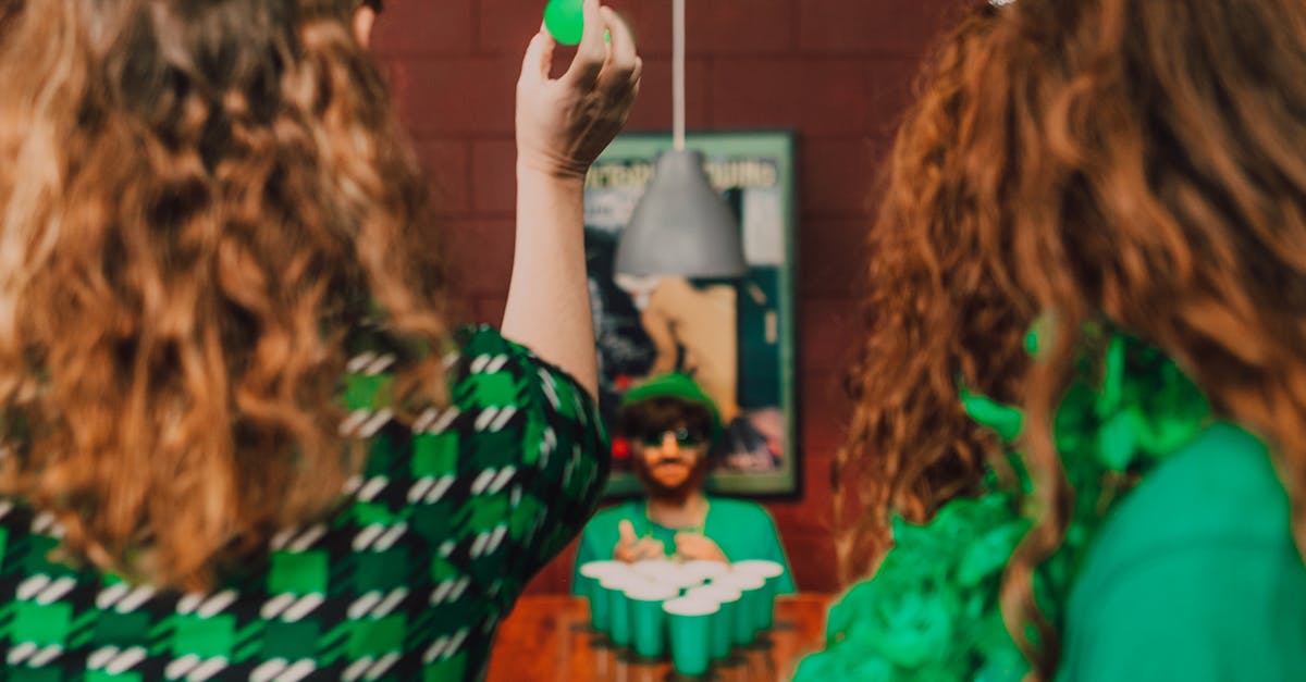 Group of adults playing games at a lively St. Patrick's Day party in festive attire.